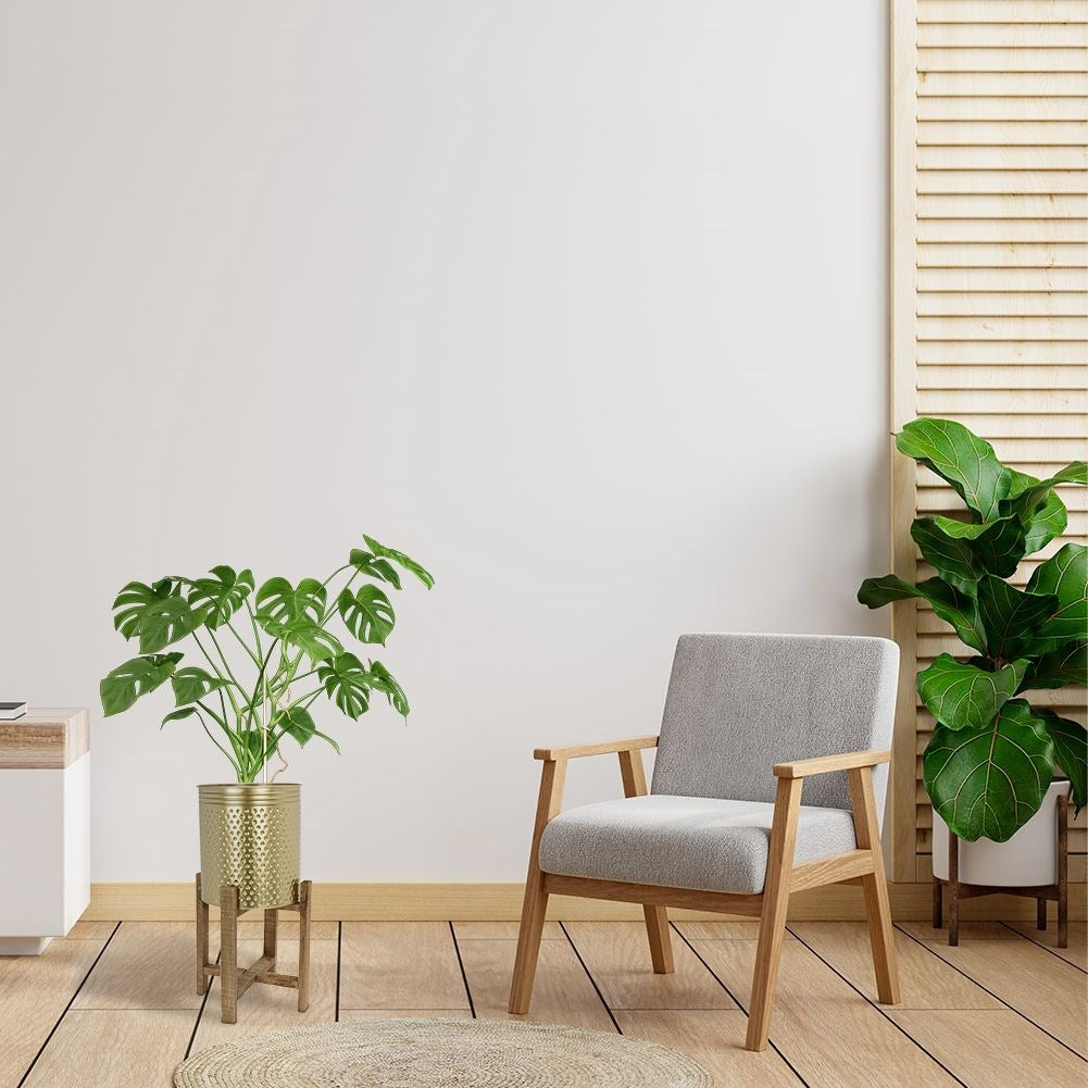 Gold colored flower pot on a wooden stand