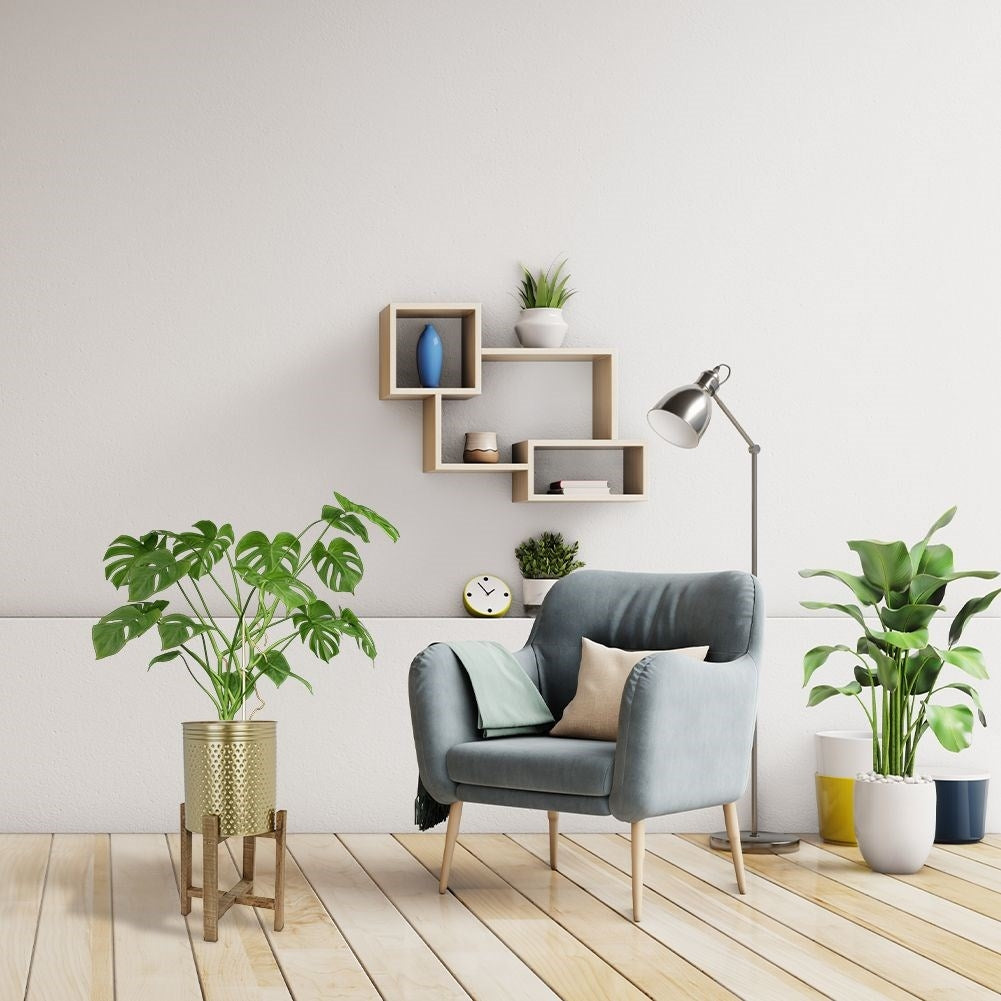 Gold colored flower pot on a wooden stand