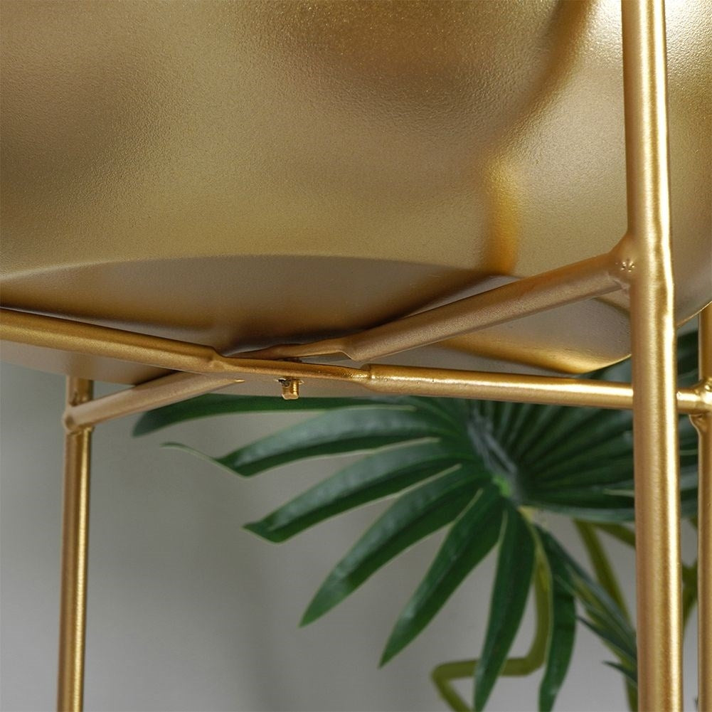 Gold colored metal pot on stand - modern and glamorous