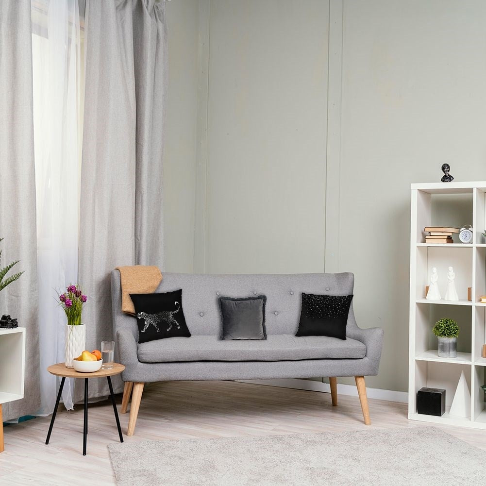 Gray velvet cushion with fur, soft and decorative.