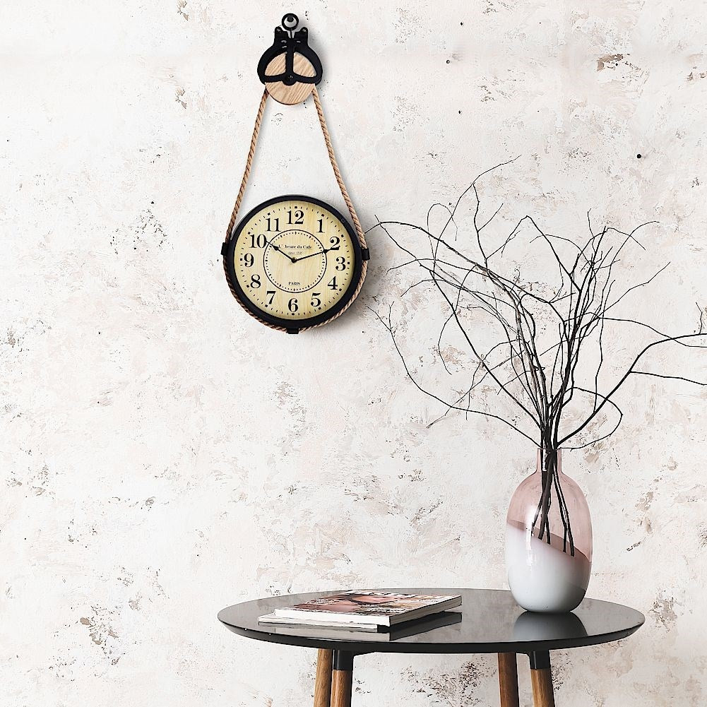 Industrial wall clock with rope suspension for modern interior design