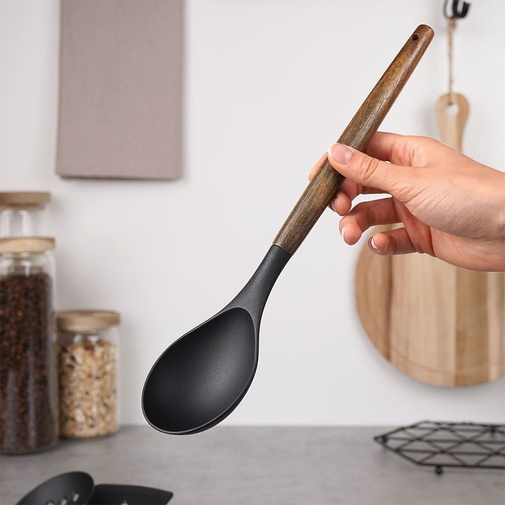 Kitchen spoon in acacia wood and thermoplastic for cooking