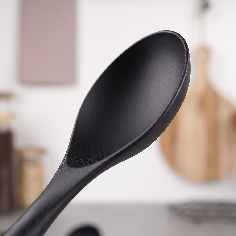 Kitchen spoon in acacia wood and thermoplastic for cooking