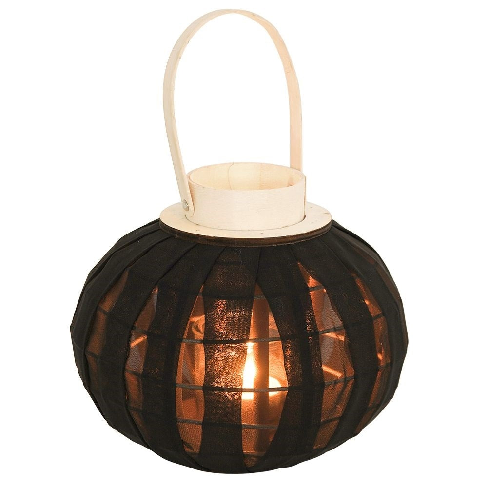 Lantern on a wooden stand with black fabric and glass inlay