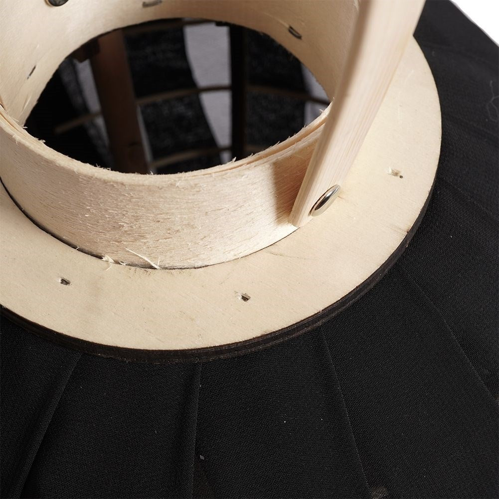 Lantern on a wooden stand with black fabric and glass inlay