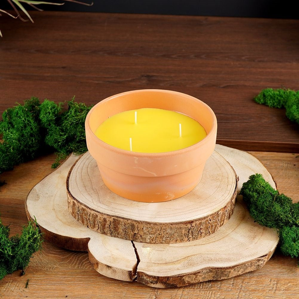 Lemon candle with three wicks in terracotta pot
