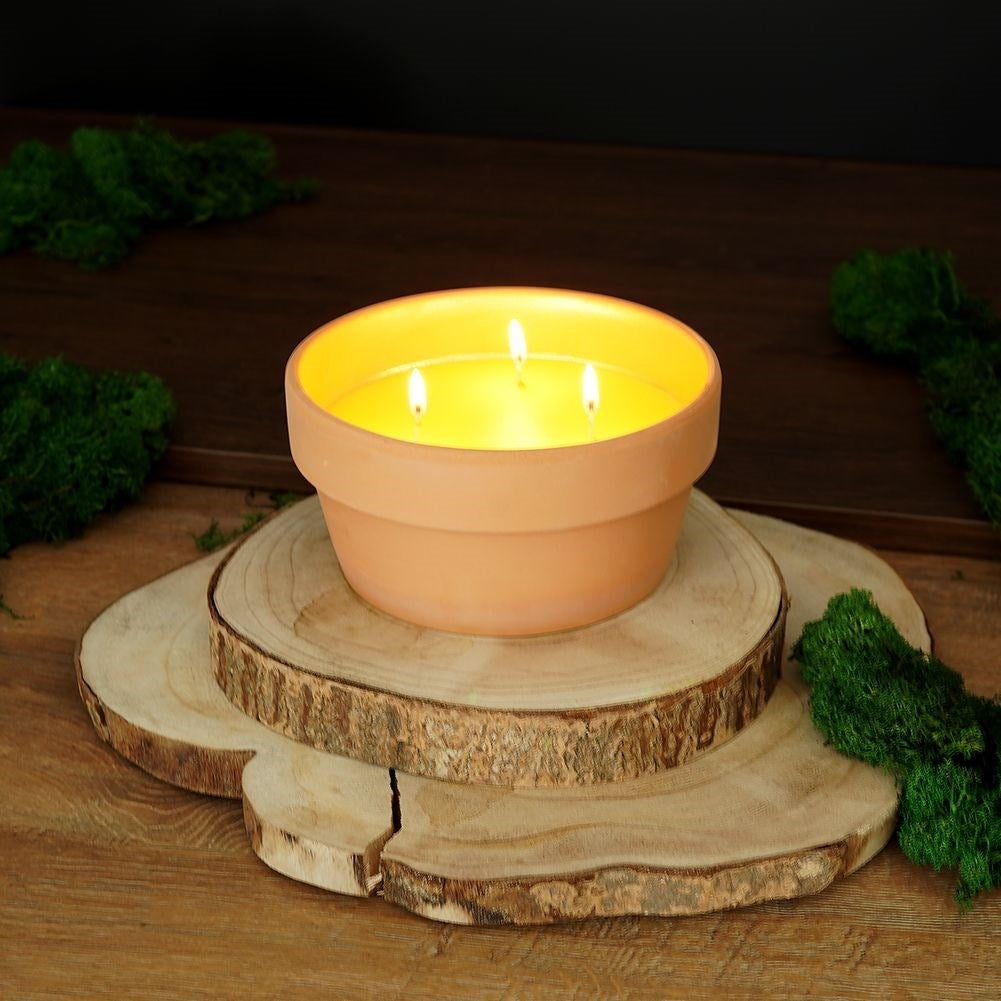 Lemon candle with three wicks in terracotta pot