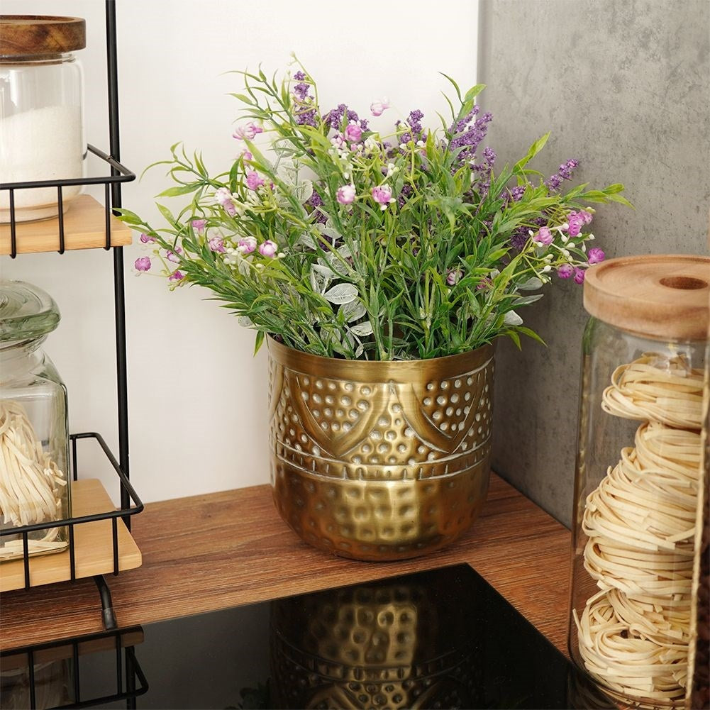 Luxurious flower pot in hammered brass with an elegant design