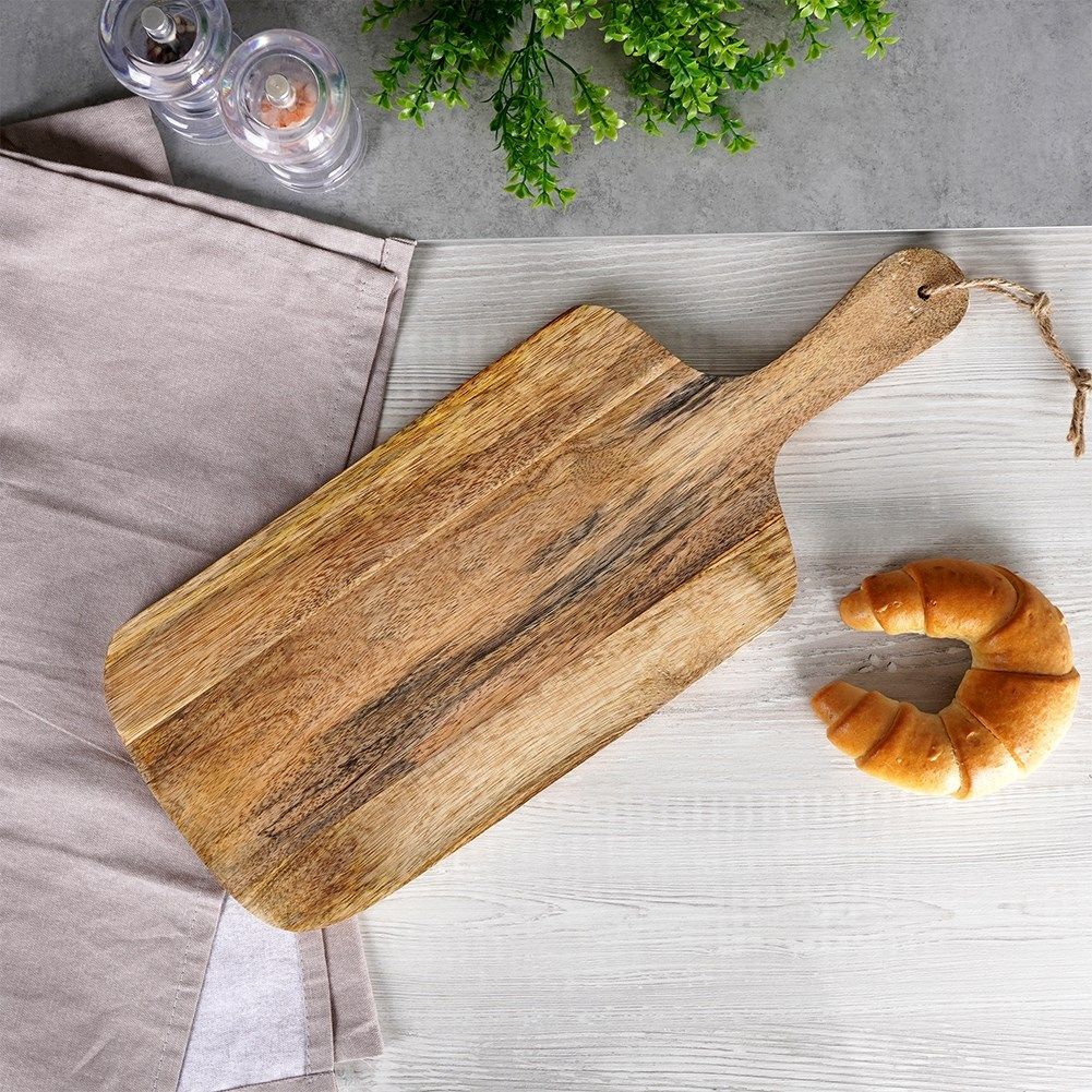 Mango wood cutting board with handle, perfect for serving.