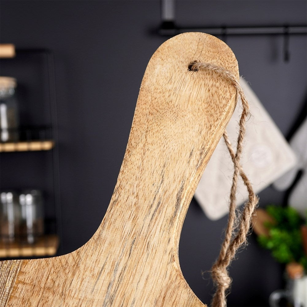 Mango wood cutting board with handle, perfect for serving.