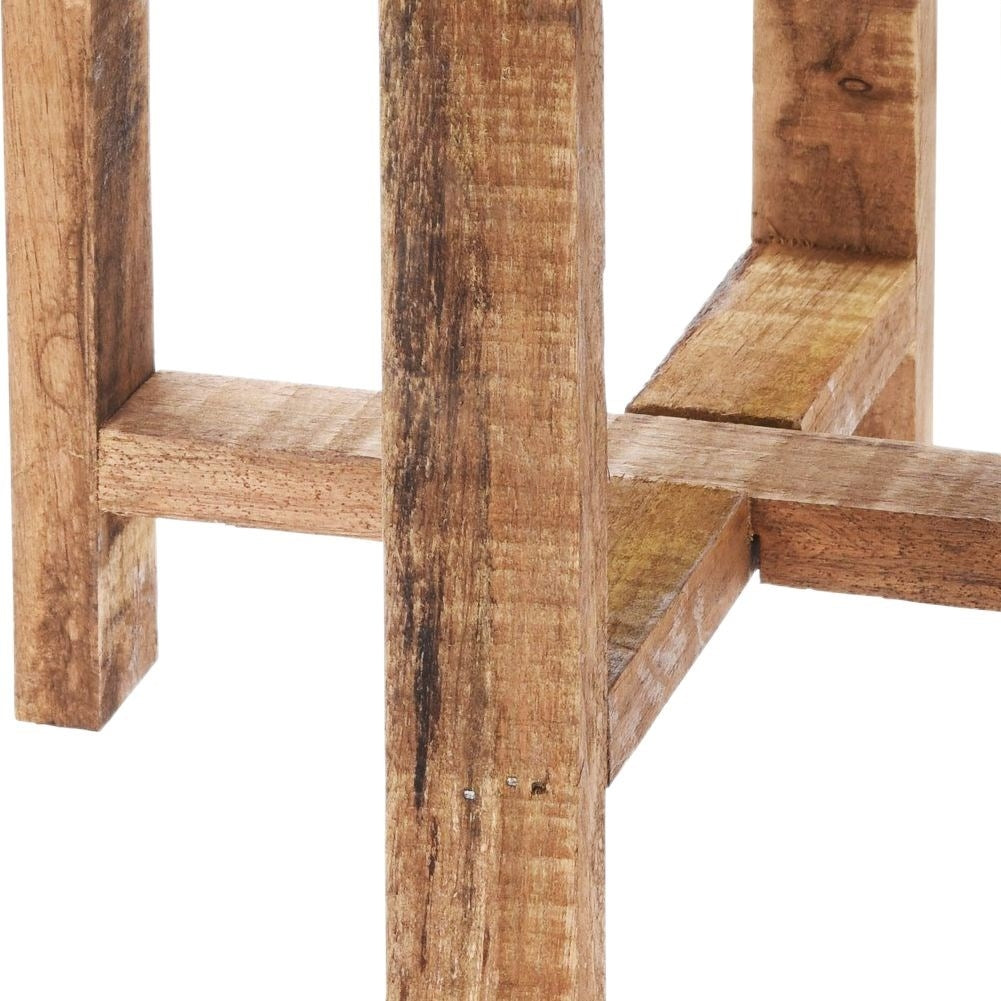 Metal flower pot on a wooden stand for modern interior design