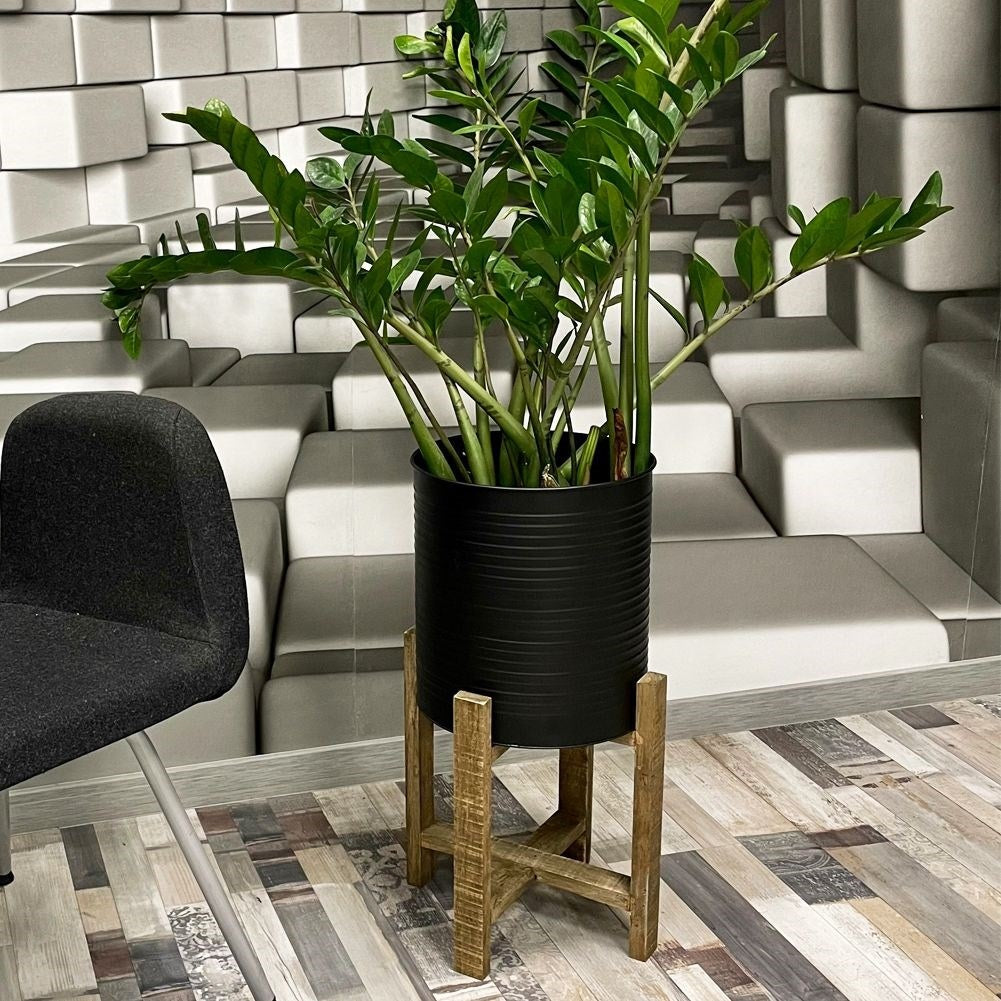 Metal flower pot on a wooden stand for modern interior design