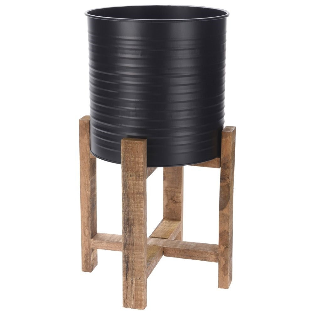 Metal flower pot on a wooden stand for modern interior design