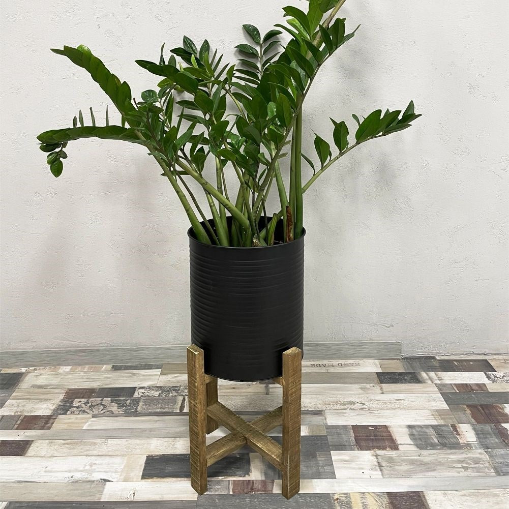 Metal flower pot on a wooden stand for modern interior design