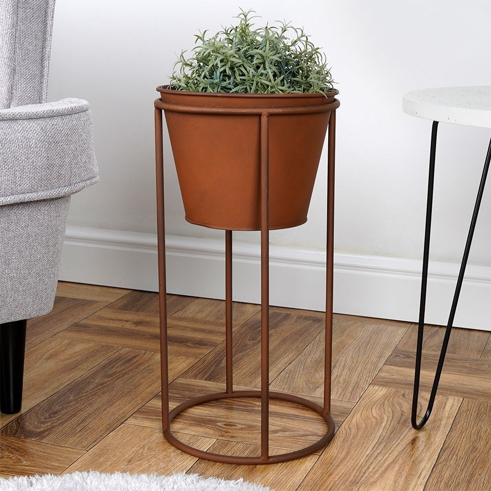 Metal flower pot on stand with rust effect