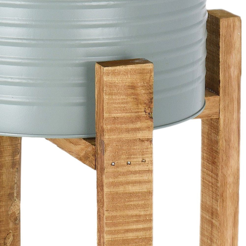 Metal flower pot with wooden stand for modern interior design