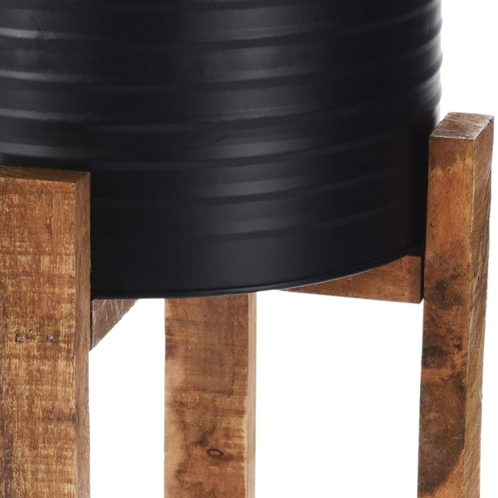 Metal flower pot with wooden stand for modern interior design