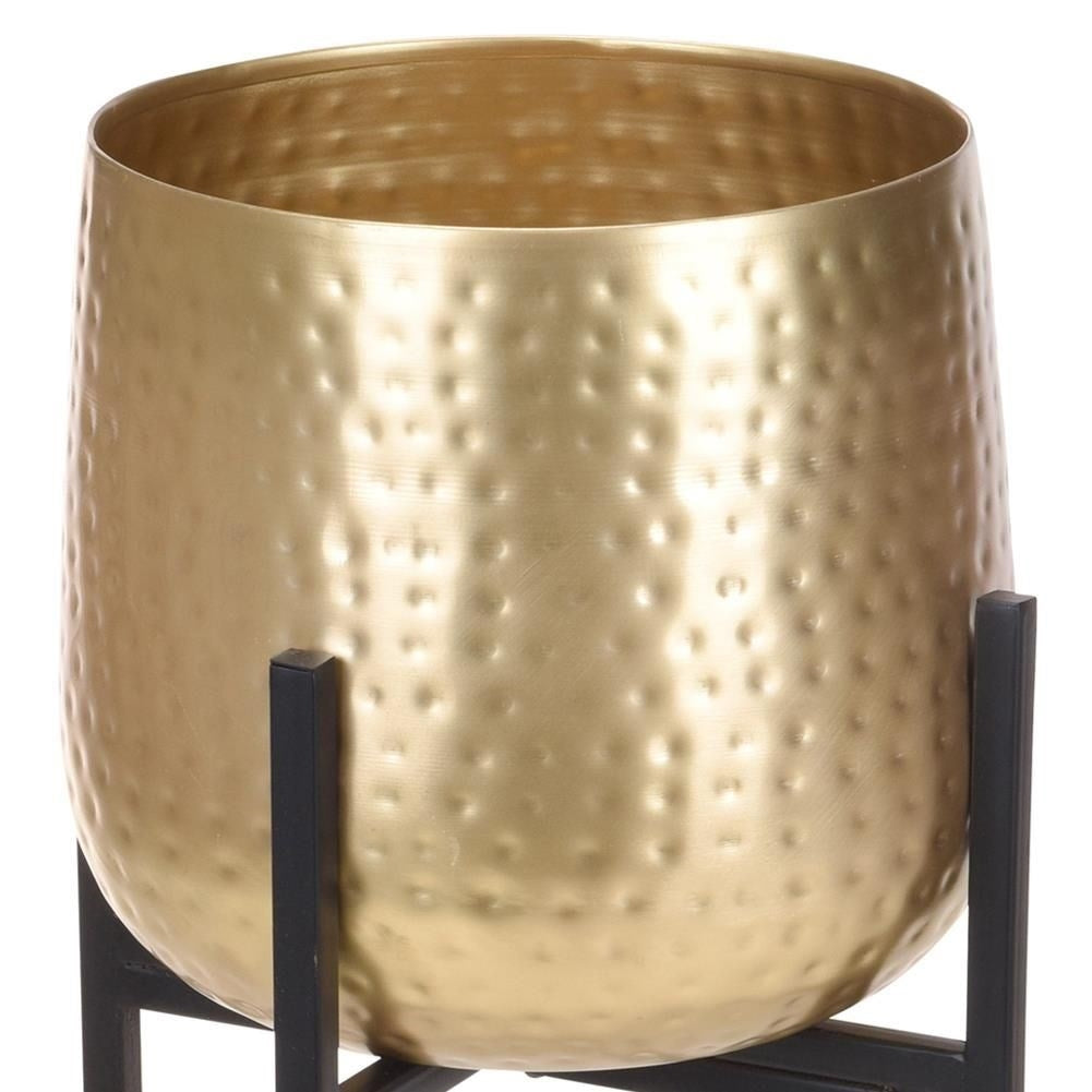 Metal pot on stand in black and gold color