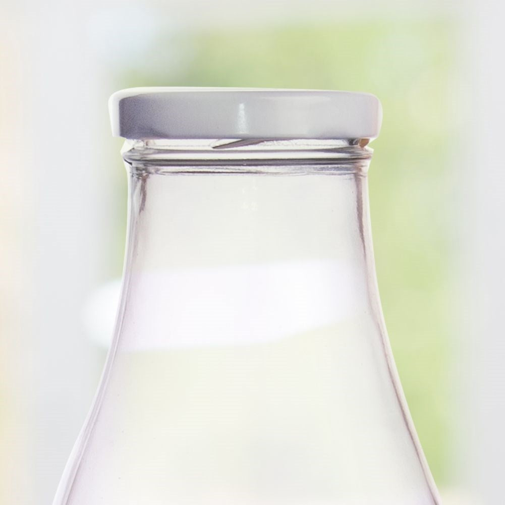 Milk bottle lid in metal with clips for longer durability
