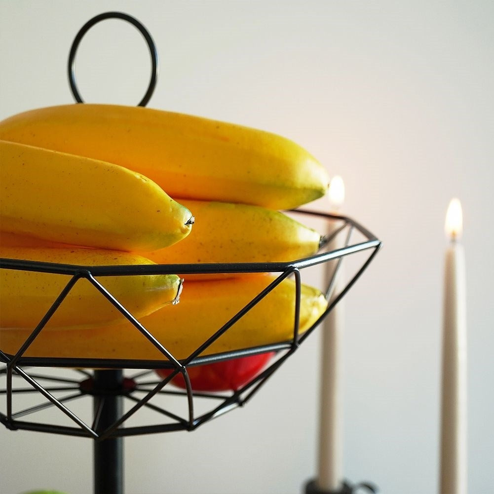 Modern two-level fruit basket in black metal for kitchen