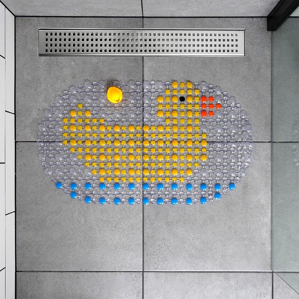 Non-slip mat with suction cups and squeaky duck for bathtubs