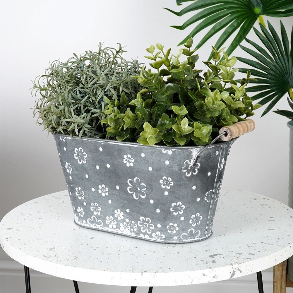 Oblong galvanized pot with handle and white flowers
