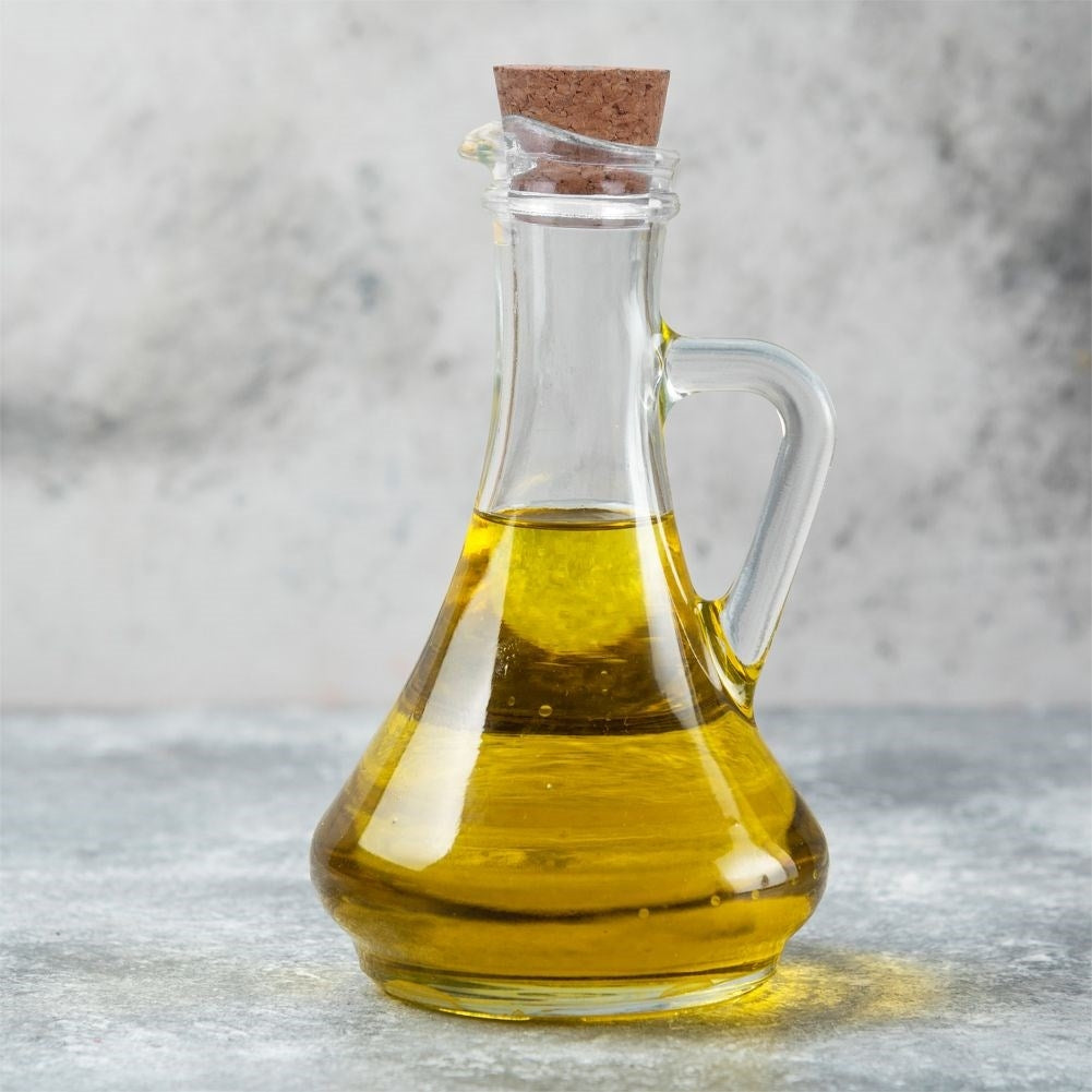 Oil bottle for serving with garlic, herbs and chilli