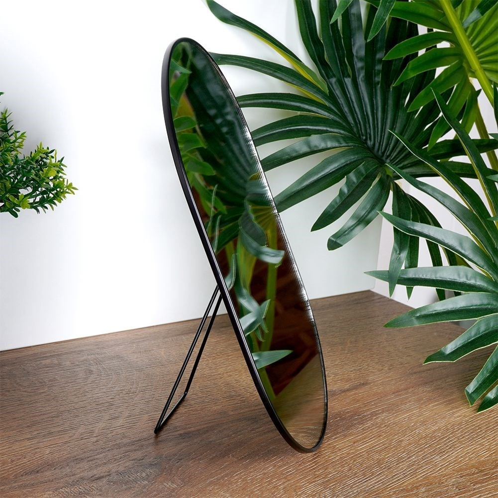Oval make-up mirror with sturdy metal base and frame