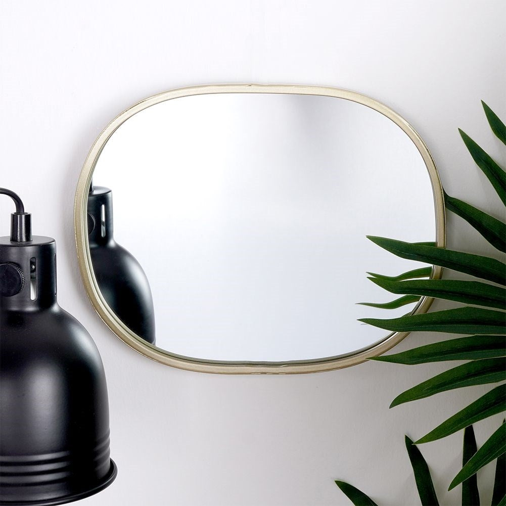 Oval wall mirror with champagne gold frame - elegant detail