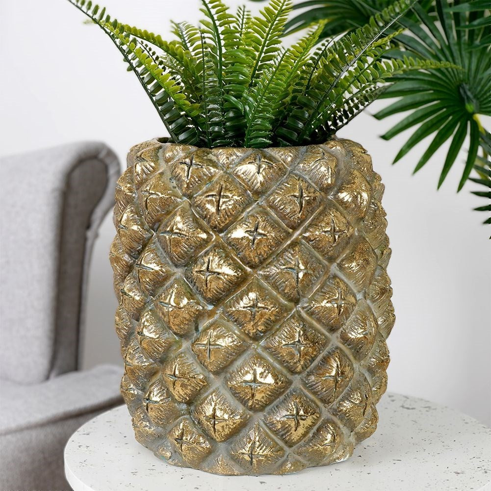 Pineapple-shaped pot in gold for exclusive interior design