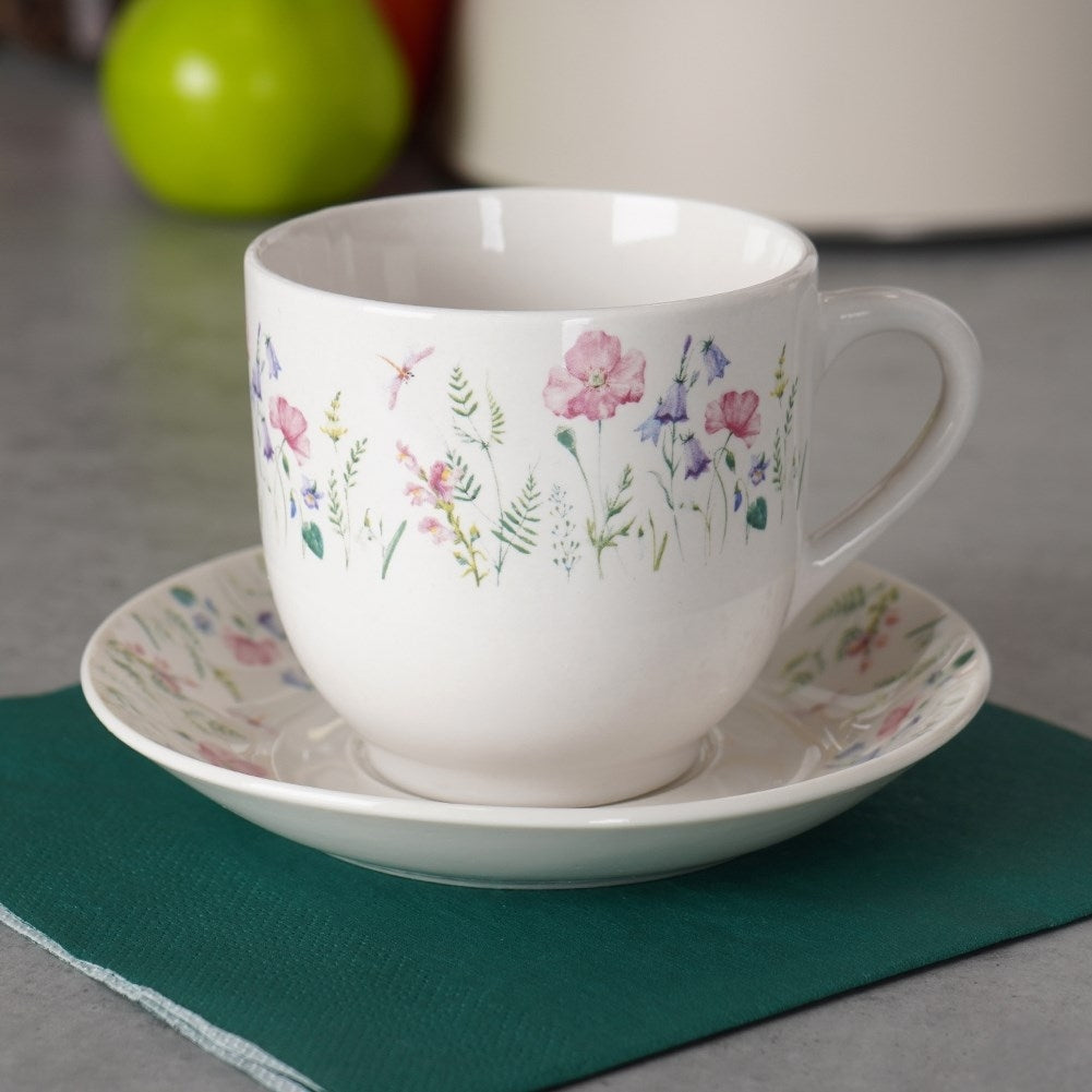 Porcelain cup with floral pattern and saucer