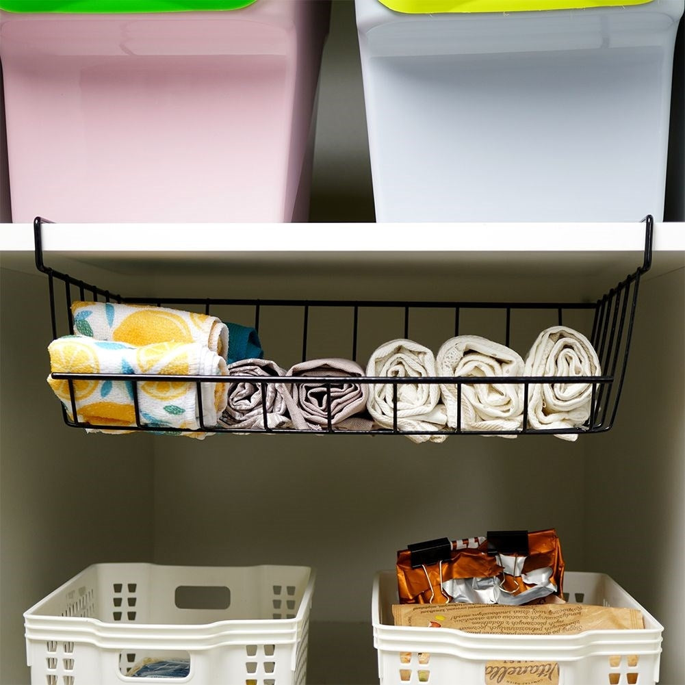Practical black metal basket for extra space under the shelf