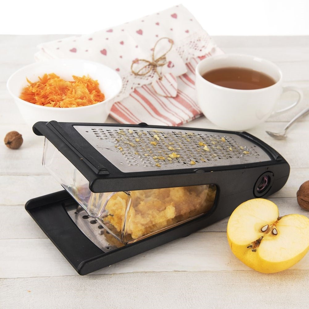 Practical kitchen grater with two blades and container in stainless steel