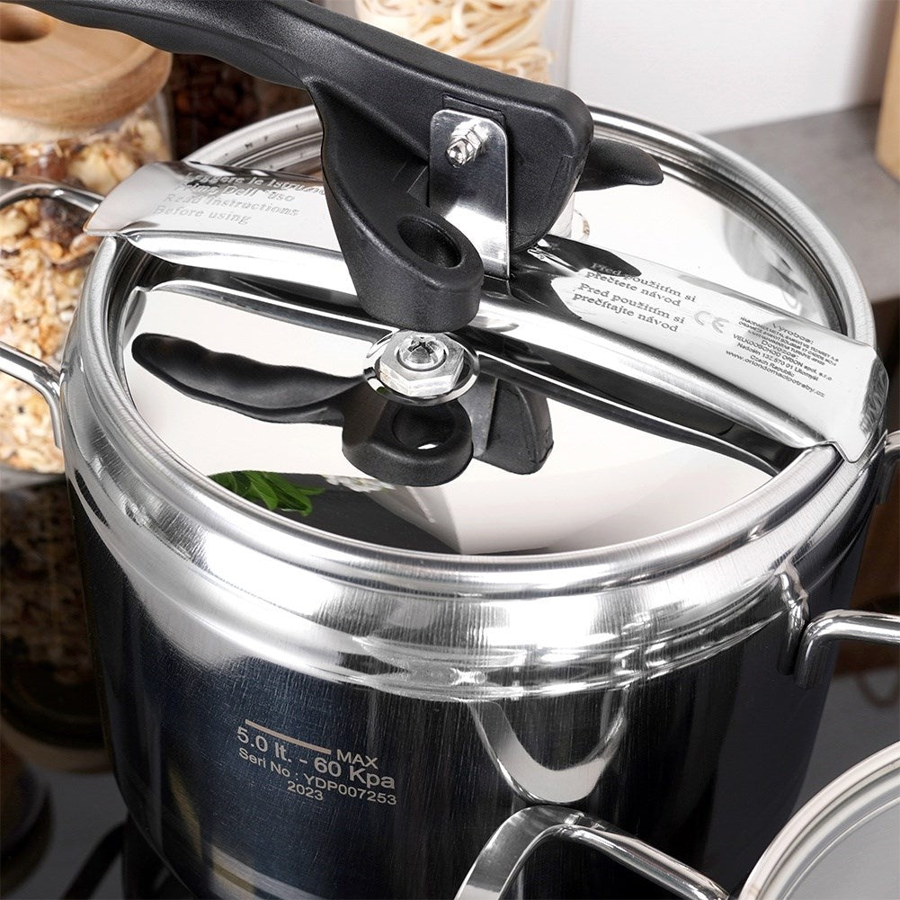 Pressure cooker with multi-layer base and safety valves