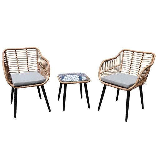 Rattan garden furniture set with chairs and a table with a glass top