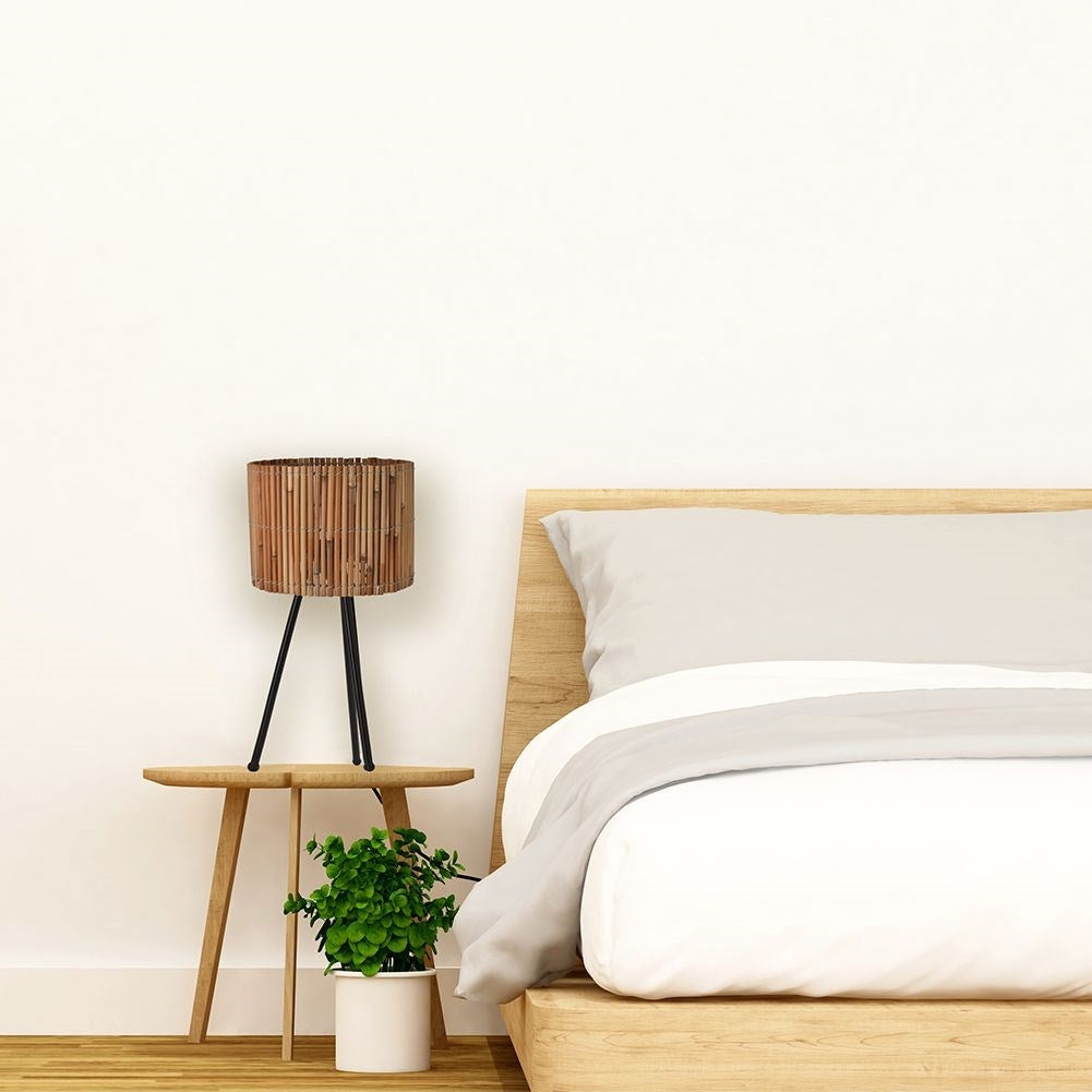 Rattan table lamp with black metal legs for any room