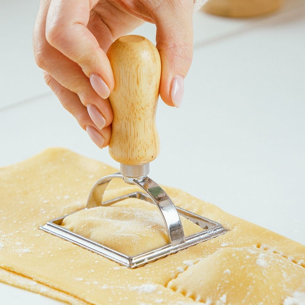 Ravioli cutter in metal and wood for uniform shapes