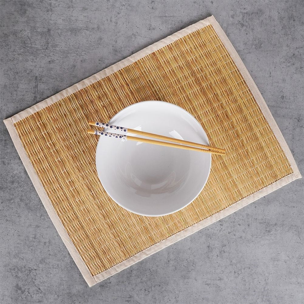 Rectangular rattan kitchen mat covered in beige cotton