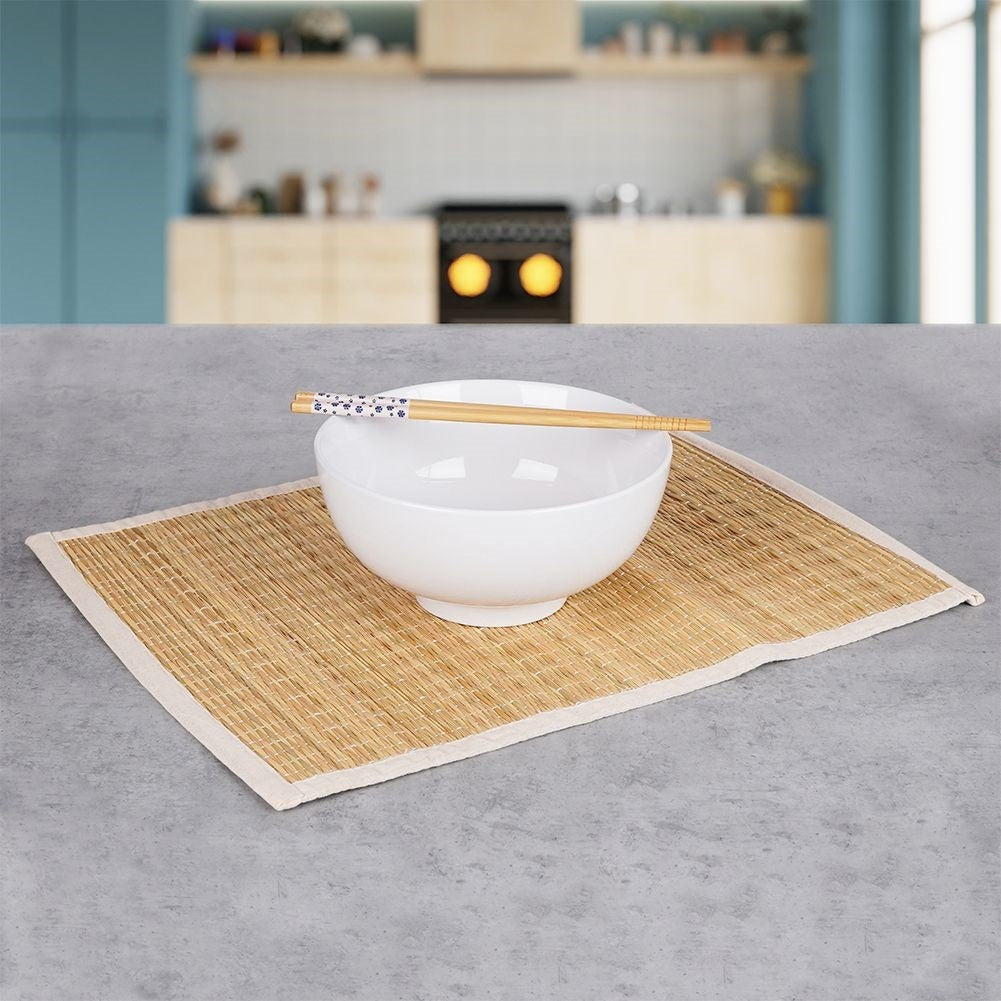 Rectangular rattan kitchen mat covered in beige cotton