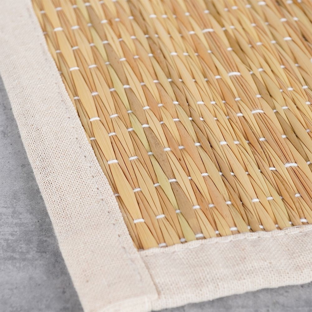 Rectangular rattan kitchen mat covered in beige cotton