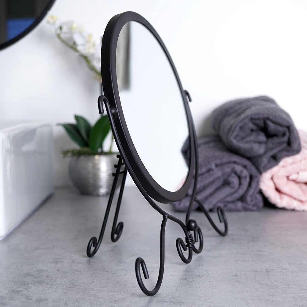 Round cosmetic mirror with stand in stylish black metal