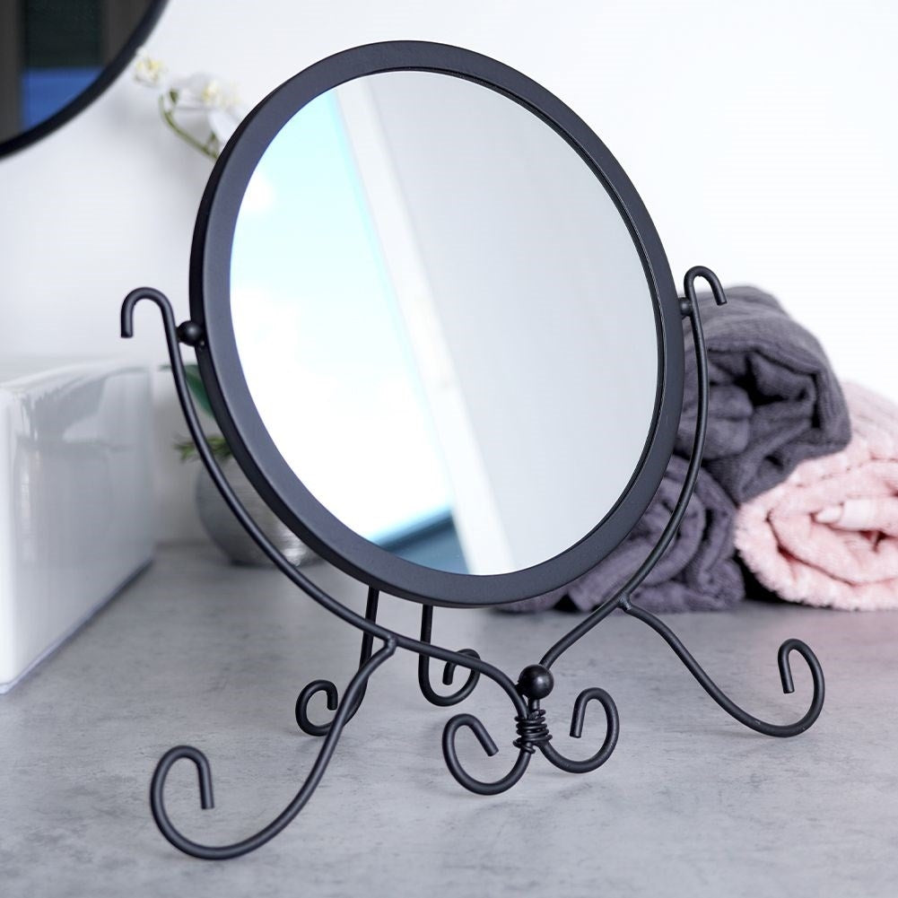 Round cosmetic mirror with stand in stylish black metal