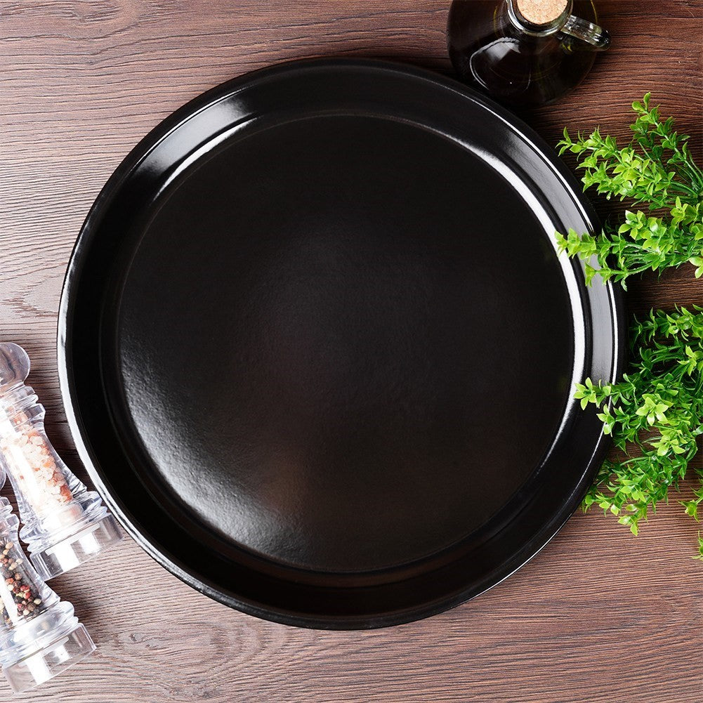 Round grill plate in steel with non-stick coating. Perfect for grilling, roasting meat and baking in the oven.round grill plate, non-stick grill plate, steel grill plate, grilling, meat baking, baking in the ovenRound steel grill plate with non-st