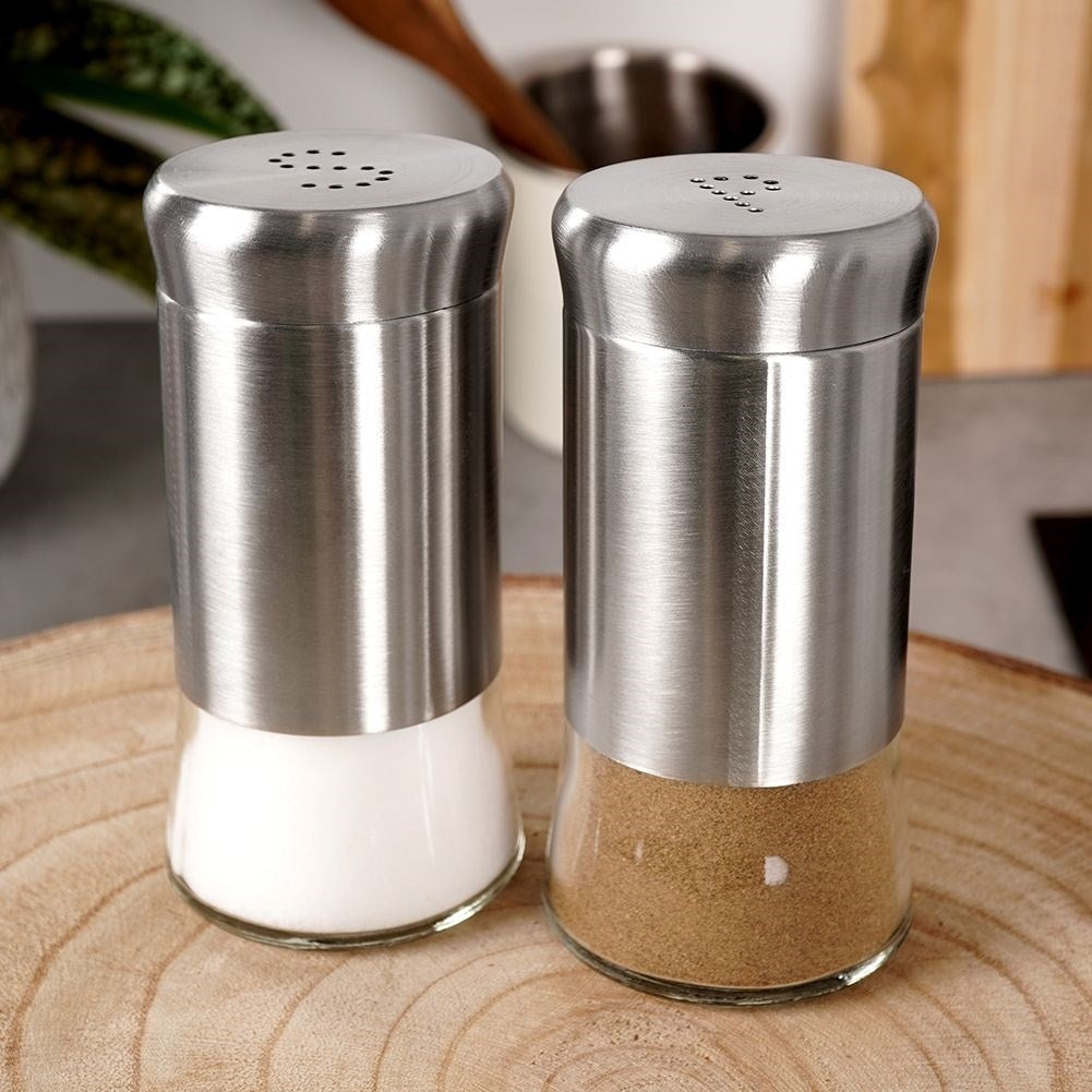 Salt and pepper shaker set in glass and stainless steel