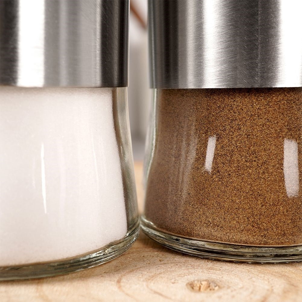 Salt and pepper shaker set in glass and stainless steel