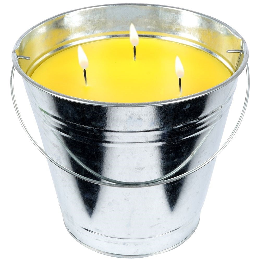 Scented candle with lemon scent and essential oil in a metal bucket