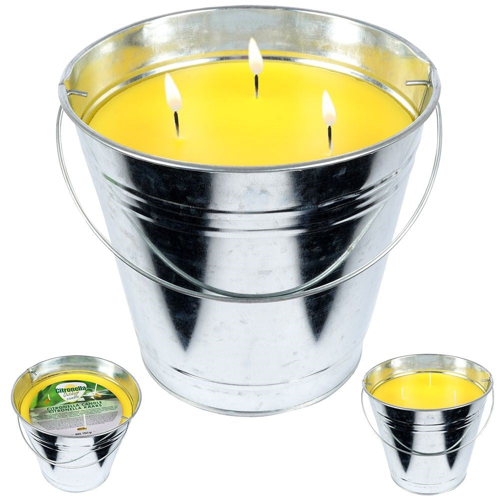 Scented candle with lemon scent and essential oil in a metal bucket
