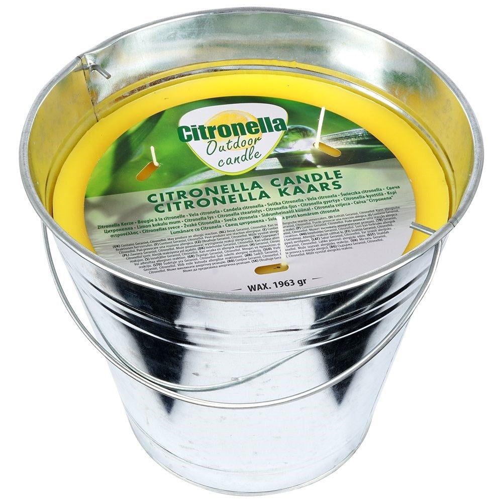 Scented candle with lemon scent and essential oil in a metal bucket