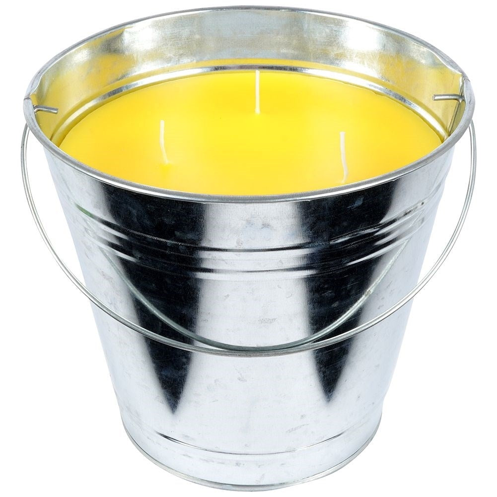 Scented candle with lemon scent and essential oil in a metal bucket