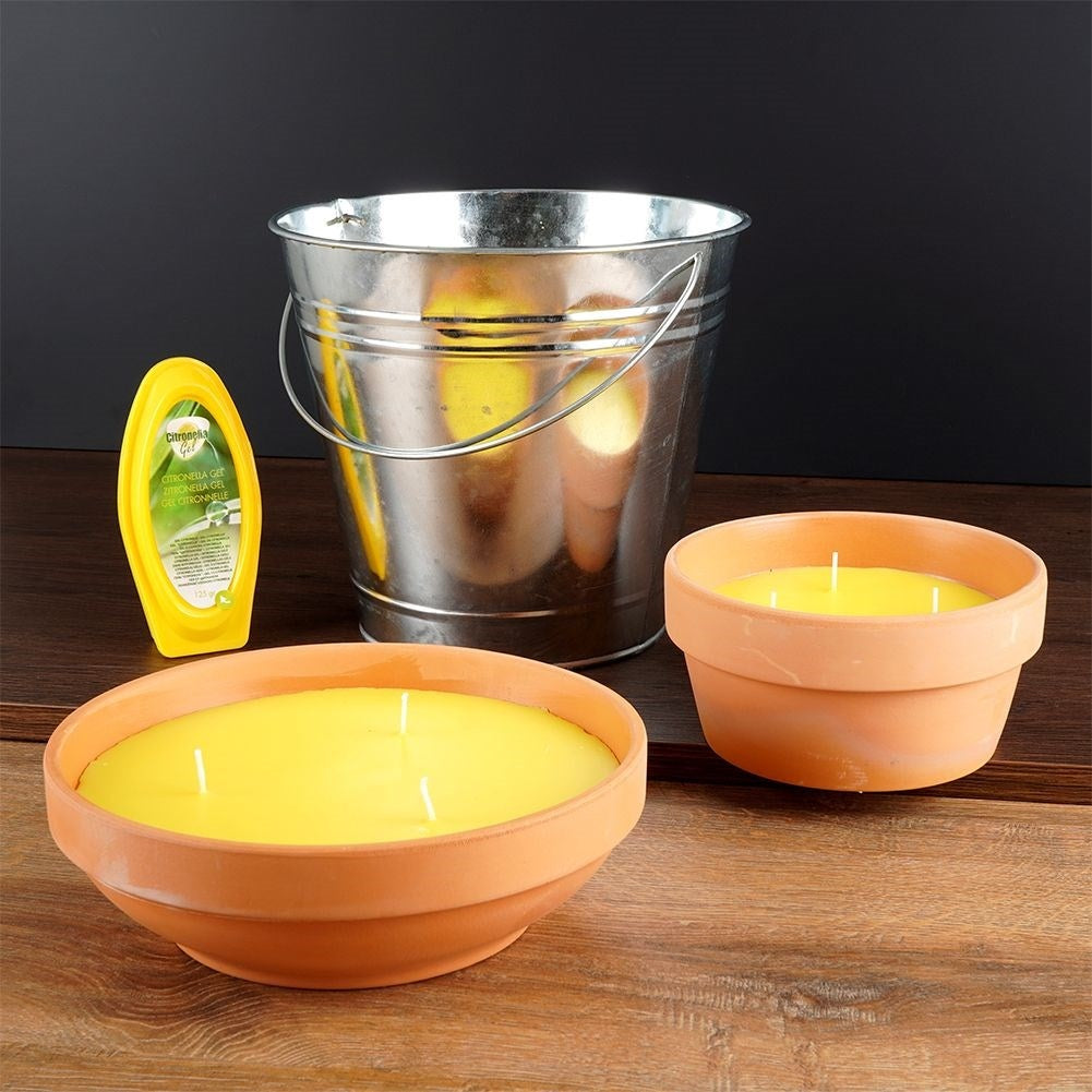 Scented candle with lemon scent and essential oil in a metal bucket